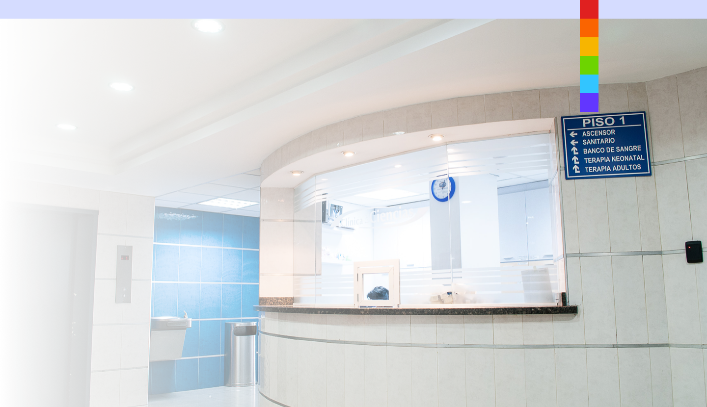 Modern hospital reception with blue signage.