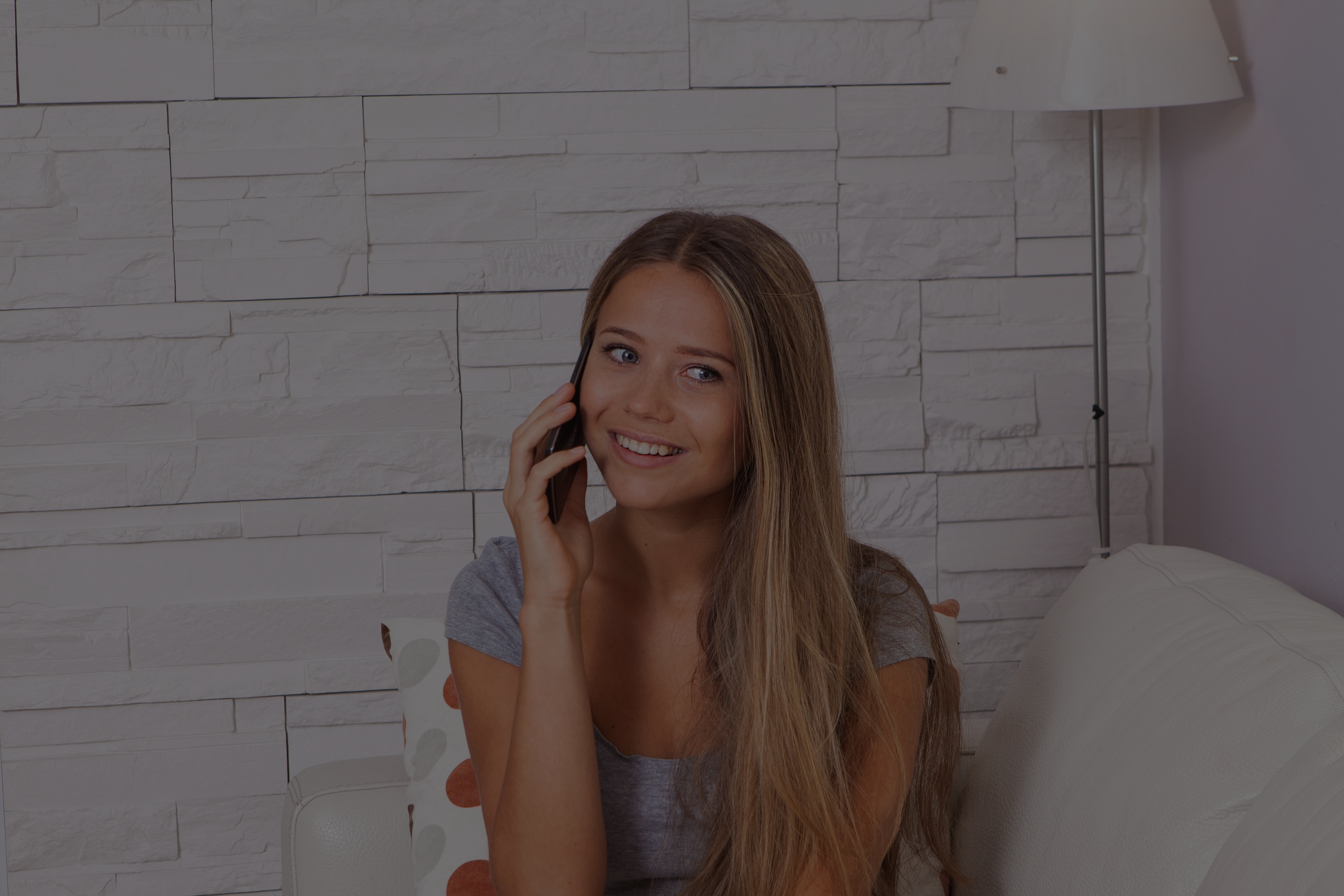 Woman smiling while talking on phone.